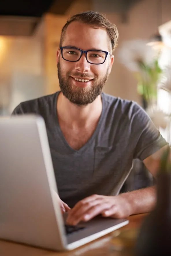 A developer at their desk, looking up from the screen